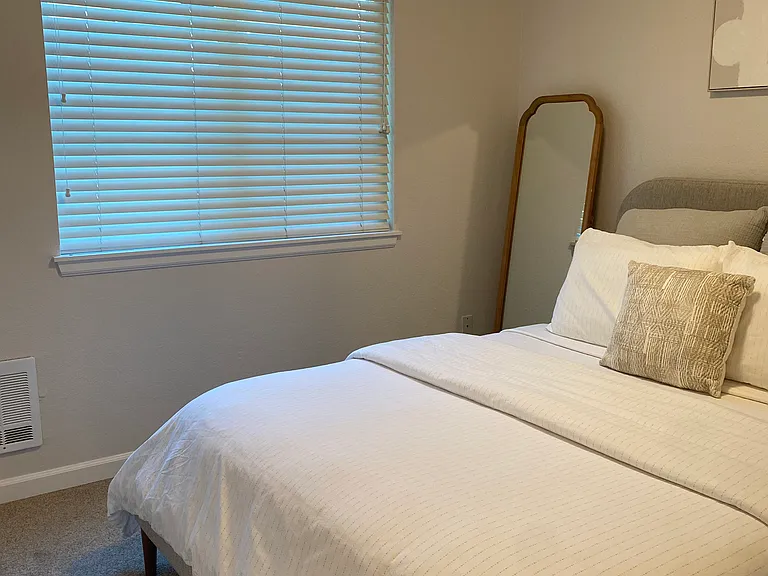 One of the apartment's two bedrooms. Blinds will remain throughout the apartment. Furniture in this pic will not.