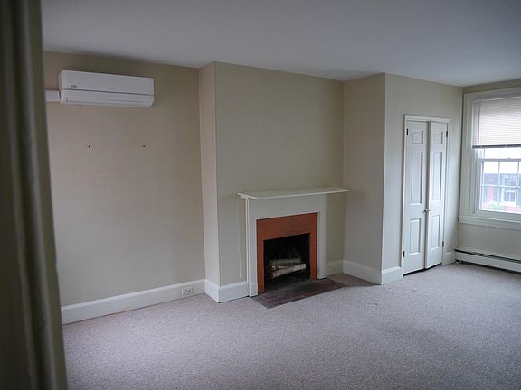 Charming and bright - living area with non-working fireplace.