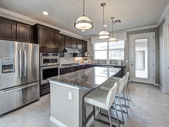Model Representation Gourmet kitchen with island 42 white maple cabinets stainless gas applian