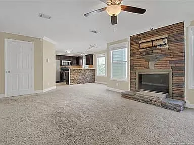 Open concept living room with adjacent pantry leading to kitchen and laundry room.