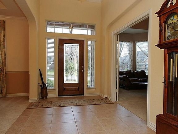 Tiled entry with leaded glass door.