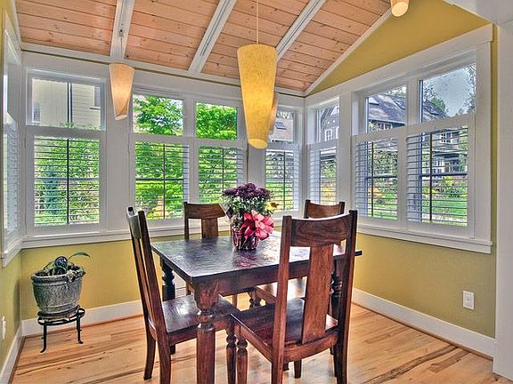 The cozy dining area with rich wood floors, detailed millwork and plenty of light.