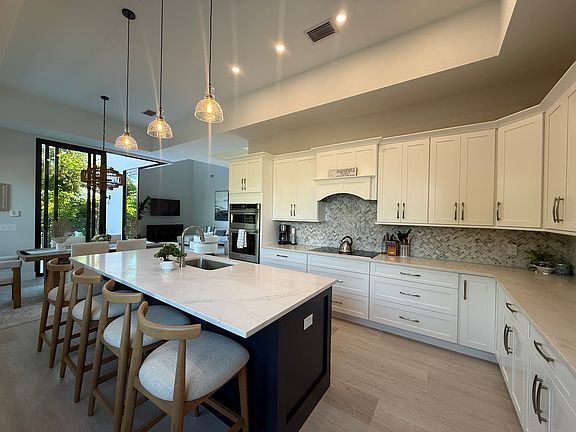 Full Kitchen with center island and dining table by the slider.