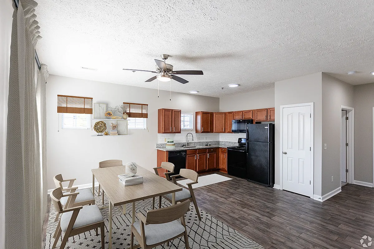 Experience modern elegance in this stylish open-concept living and kitchen area. - Port Royal at Spring Hill