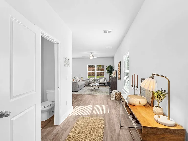 Inviting entryway of the Rosewood floor plan leading to the living room and half bath.