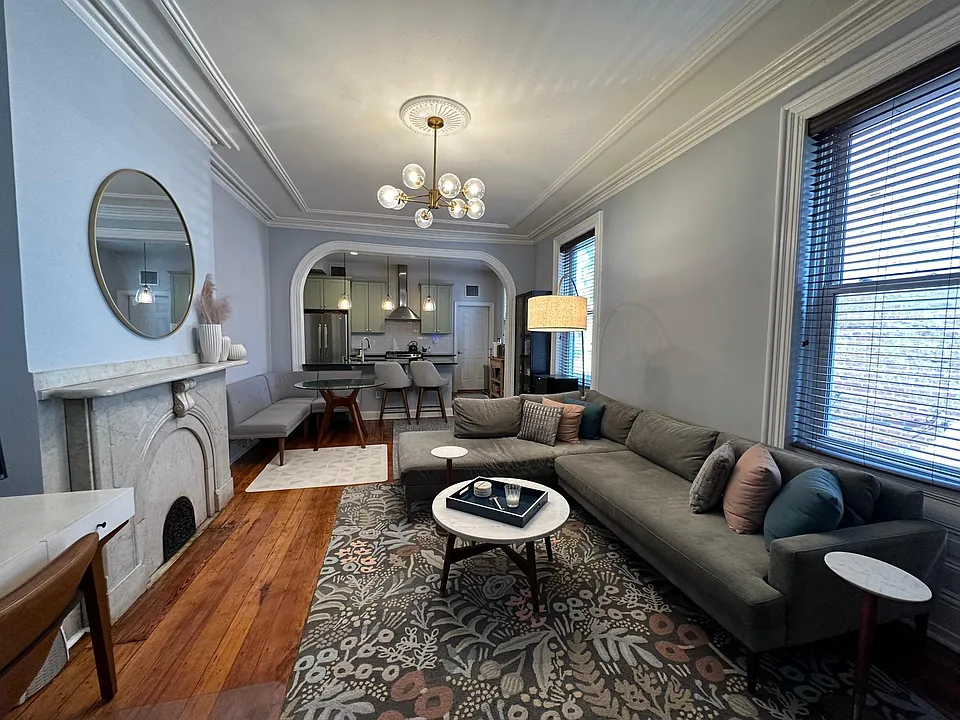 Living Room with original wood floors and decorative original fireplace