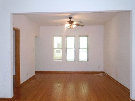 Living Room with a Nice Row of Windows and Wood Flooring