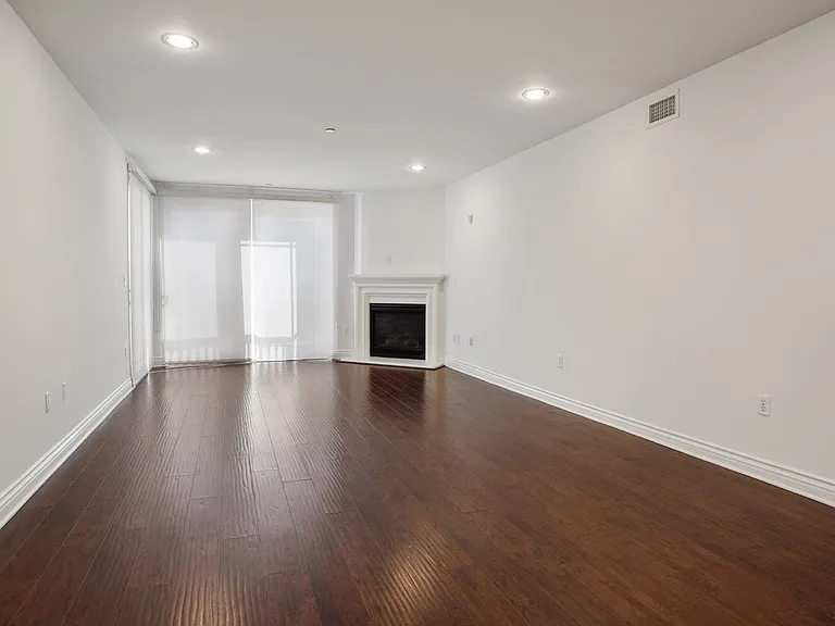 Living Room with Electric Fireplace, Recessed Lighting, Vinyl Flooring, and Patio
