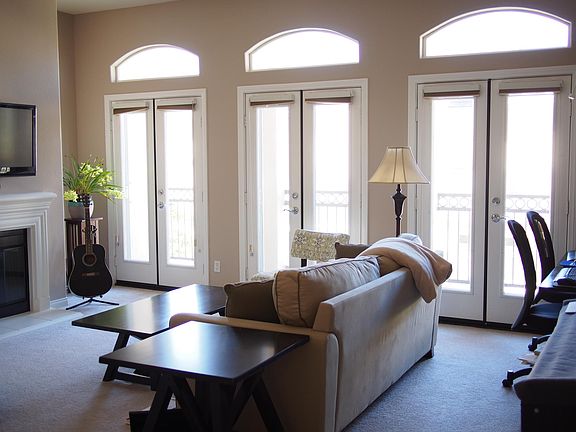 Family room with fire place, 3 French doors with retractable screens, lofted ceilings