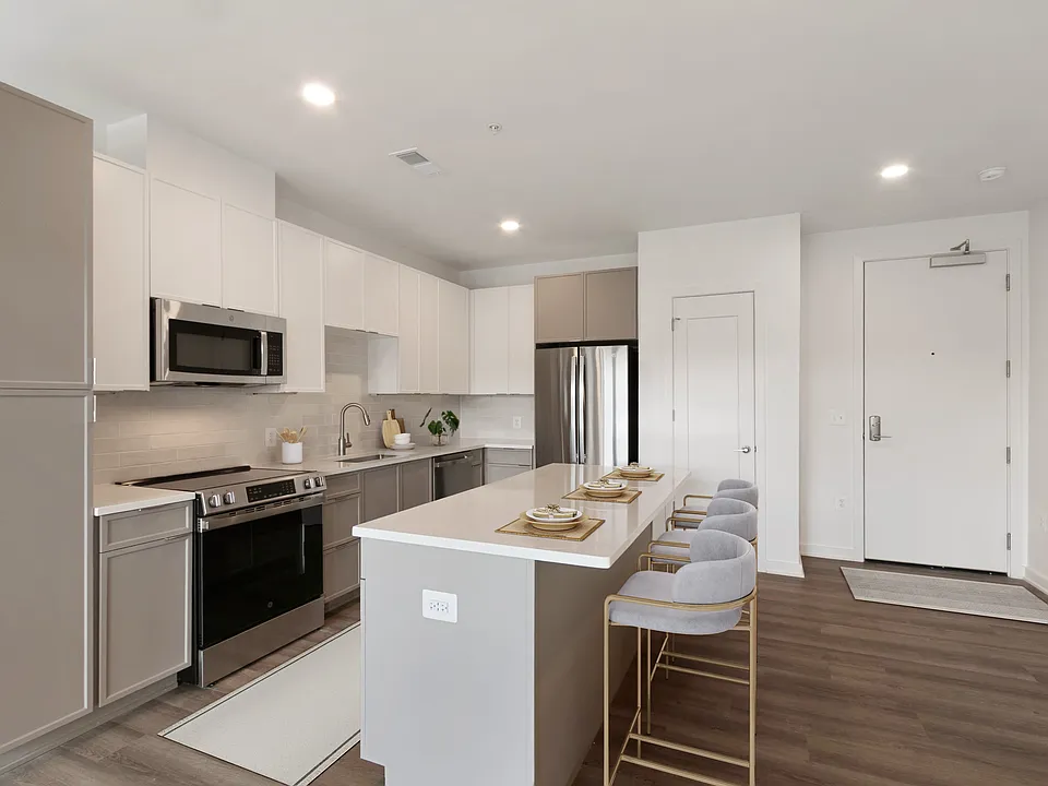 Prepare meals in a brand-new apartment kitchen with granite countertops and designer cabinetry.