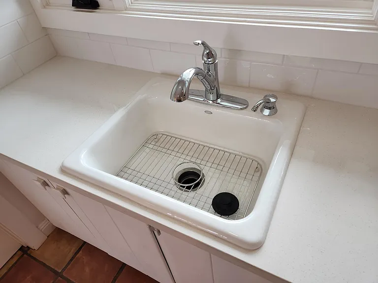Full cast iron sink with sprayer and disposal.