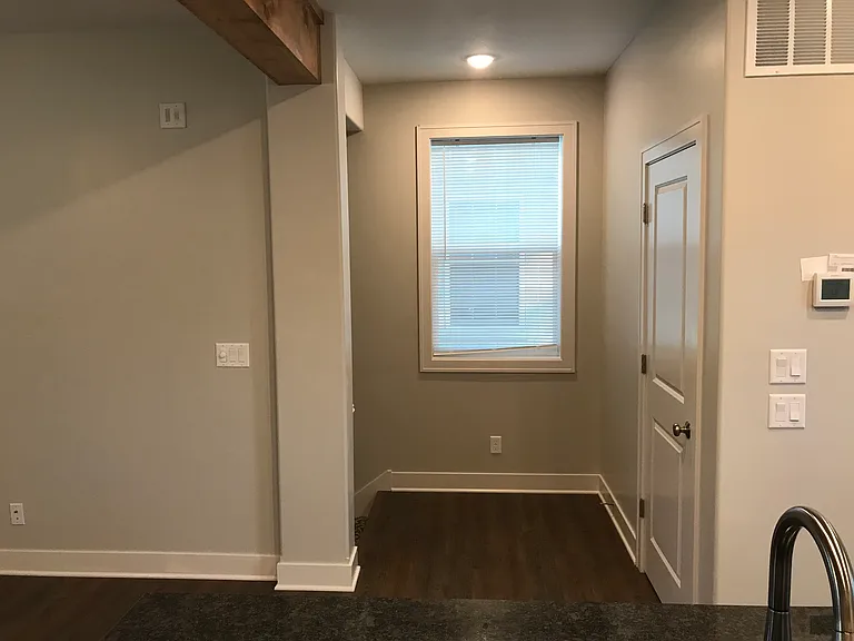 Main floor looking l towards stairs, entry closet to right