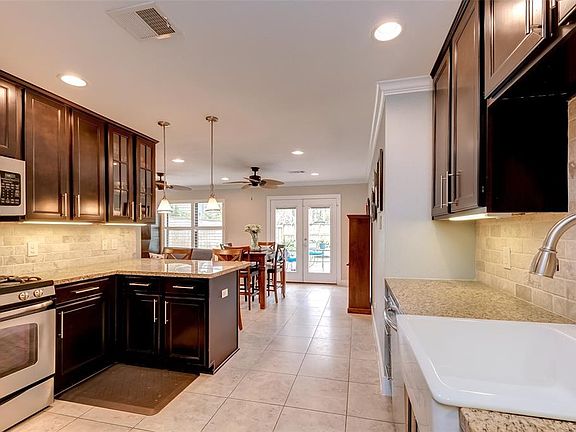 Kitchen opens up to the dining room and den.