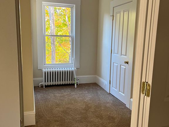 Small room in primary bedroom suite between bedroom and bathroom