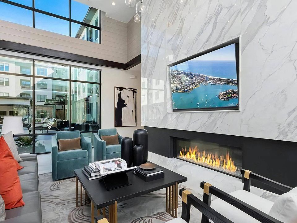 Cozy Resident Lounge with Floor-to-Ceiling Windows and Fireplace