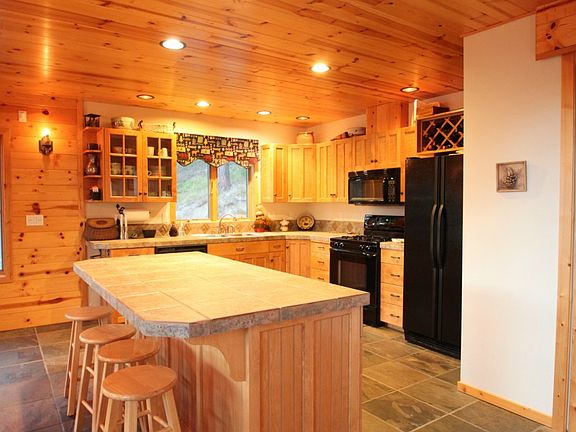 Kitchen with center island and eating bar is open to both the dining area and living room.