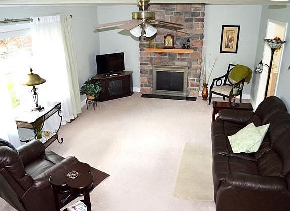 Main level living room with stone fireplace