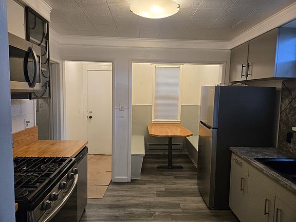 kitchen with new appliances and build in breakfast nook. Back door to back yard