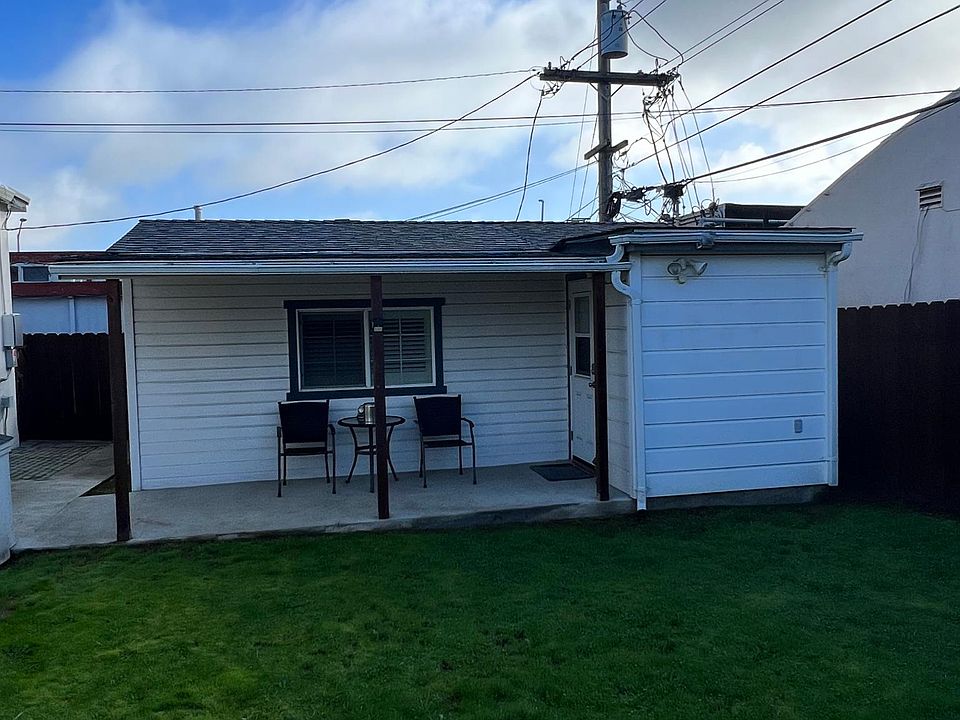 West side of cottage with patio table and chairs