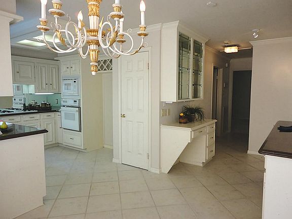 Sundrenched breakfast room... showcases dazzling chandelier and delightful view of yard - perfect place for morning coffee.