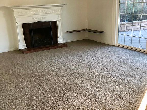 Large family room with fireplace. Brand new carpet and light streaming in. Beautiful doors to the spacious backyard.