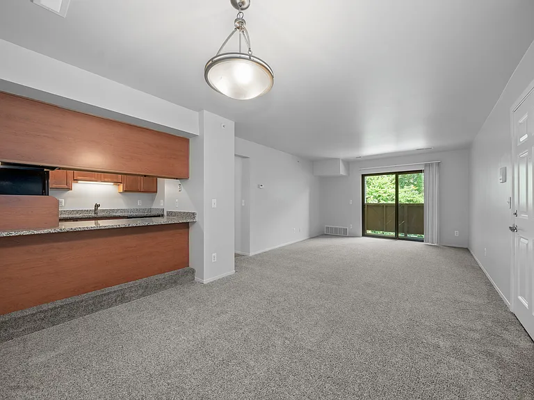 Cozy living room with natural light at Woodland Villa Apartments in Westland, MI.
