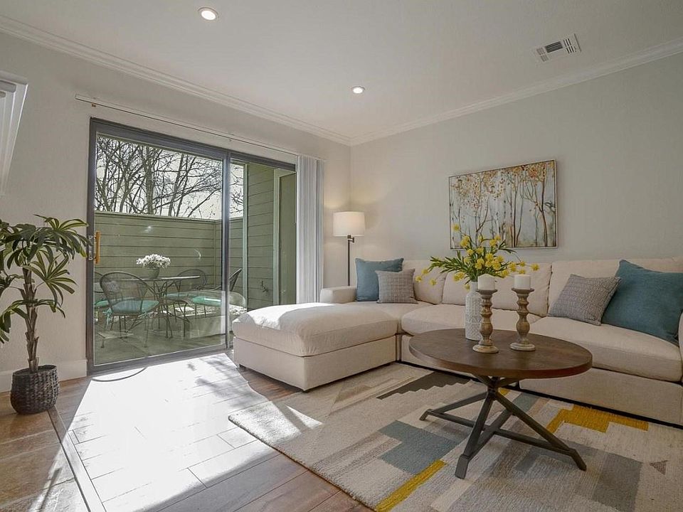 Bright, airy, quiet 1st floor unit with living room and patio with view of trees and sky