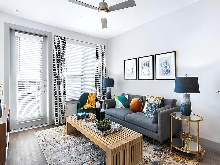 Bright Living Room with Expansive Windows and Modern Ceiling Fan