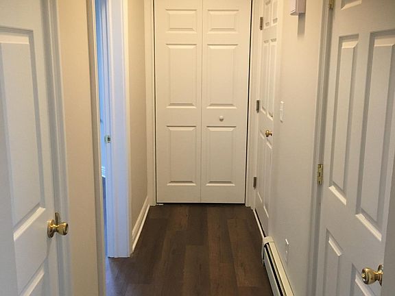 Hallway. Large closet at far end. Linen closet to left. Private door to basement which has a lock (because the basement is shared with washer and dryer).