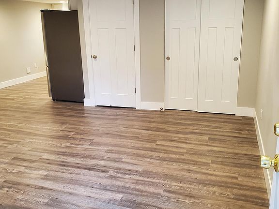 From entry door, looking in at entry closet, laundry closet & partially into kitchen.