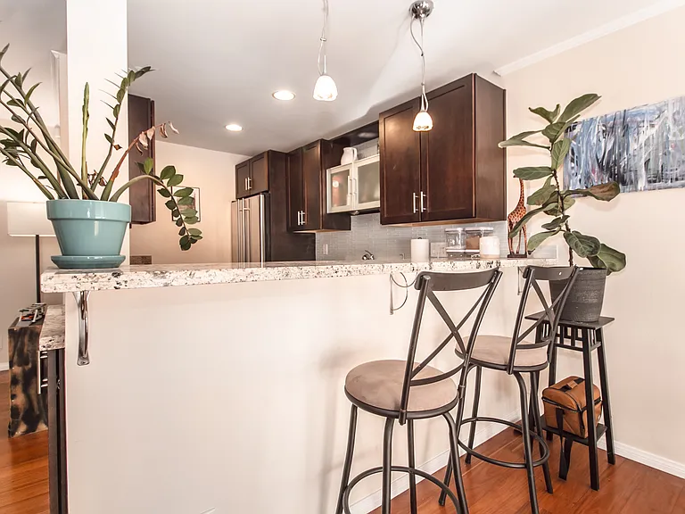 Bar Area and Stools to Kitchen