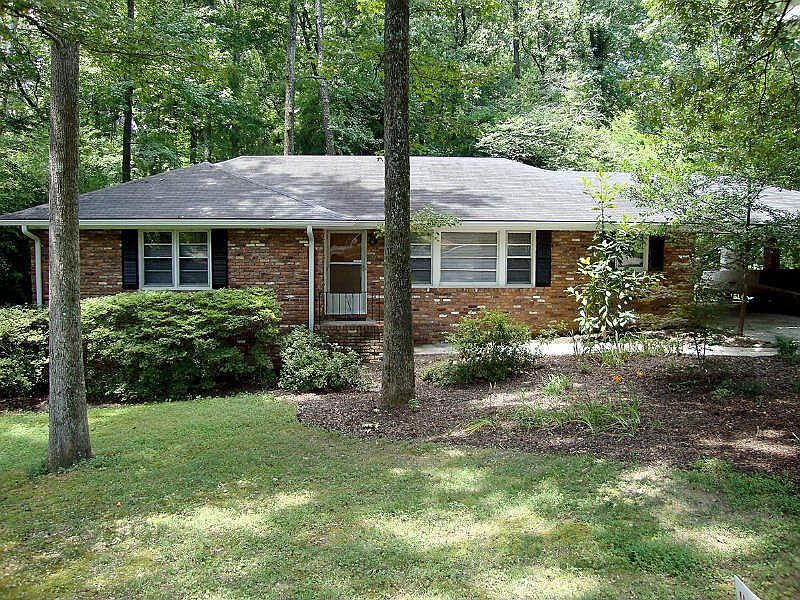 Front of home, 3 car carport on right