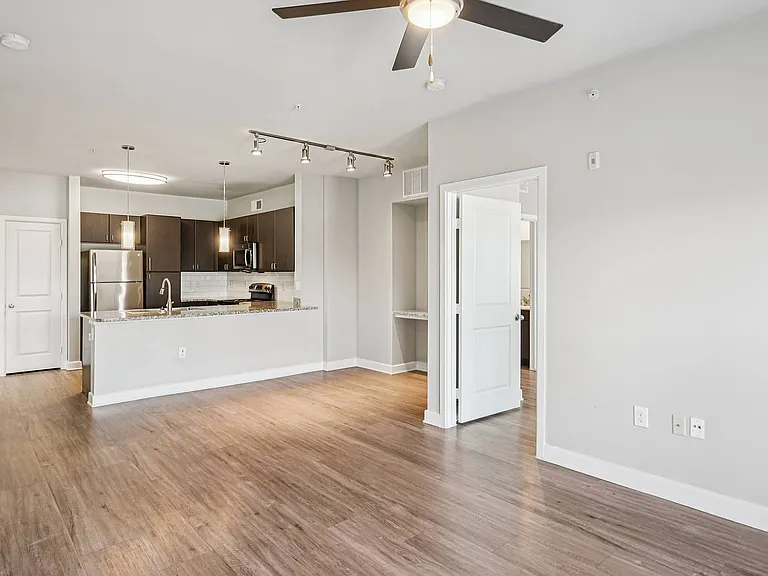 Experience the open-concept kitchen and living area at Addison Keller Springs, featuring contemporary finishes and natural light.