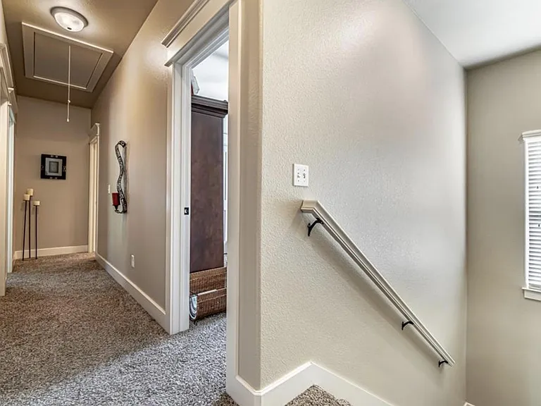 2nd floor hallway. 2 bedrooms on left side, bathroom and bedroom on right side. Space in attic to store boxes.