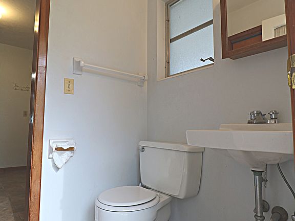 Half bath located off the utility room