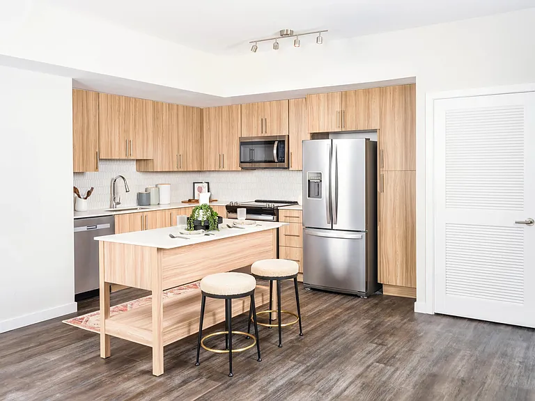 Gourmet kitchens with a spacious chef's island, built-in storage, and single-basin sink.