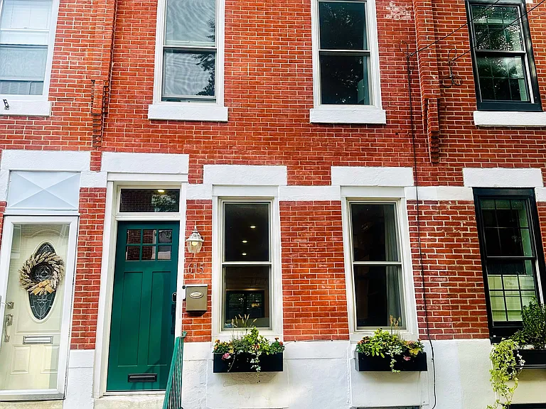 Front of home with professionally managed and self-watering window boxes