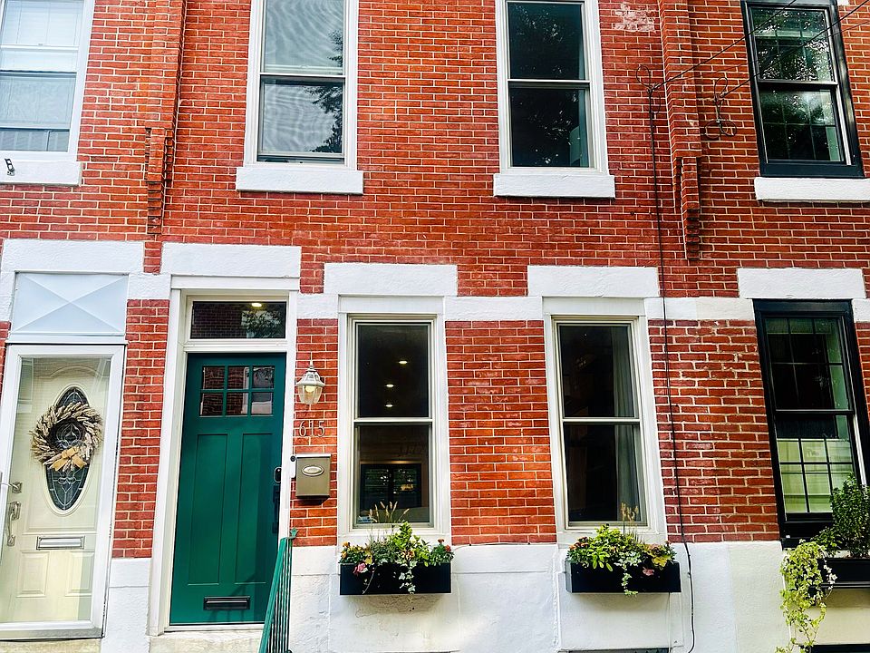 Front of home with professionally managed and self-watering window boxes