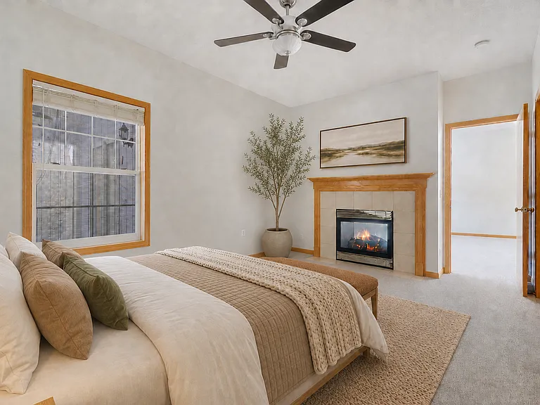 Elegant Primary Bedroom with fireplace, private bath and walk in closet.