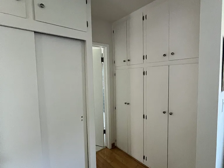 Storage in bedroom heading into the bathroom