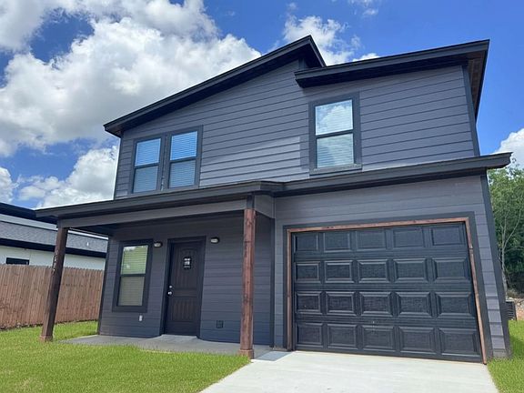 Exterior of this brand-new single-family 3/2.5 home with a covered porch and patio. Beautiful, large lot in the growing community of Comanche Cove