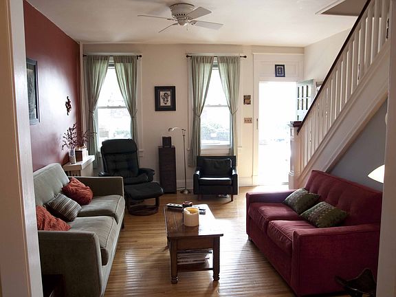 Large open living space with high ceilings and beautiful morning light.