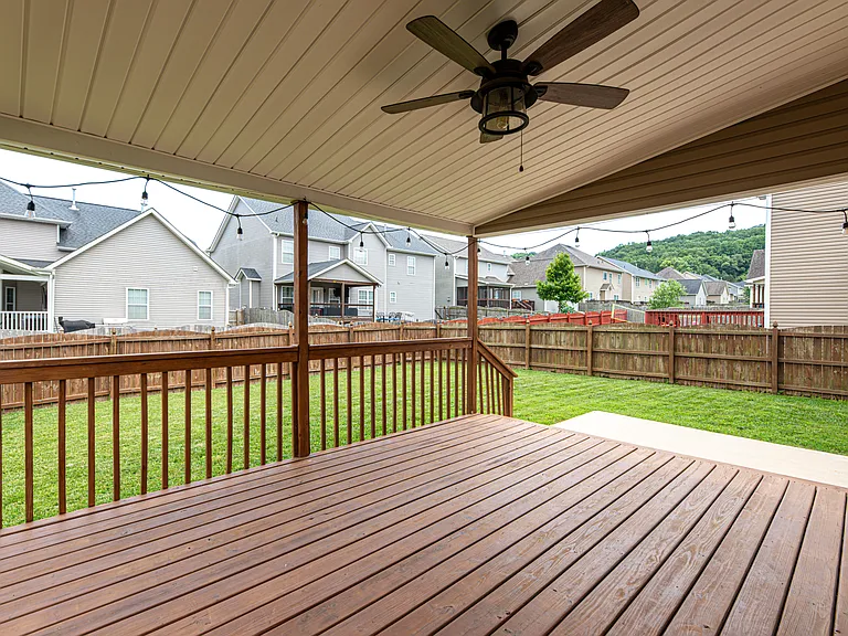 Relax in a fully fenced-in backyard designed for entertaining. The upper deck steps down to a dedicated concrete pad perfect for grilling. Unwind in the evening under the cozy string lighting or watch the game on the outdoor tv