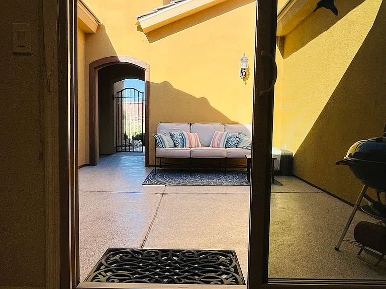 Sliders from kitchen to front, gated courtyard.