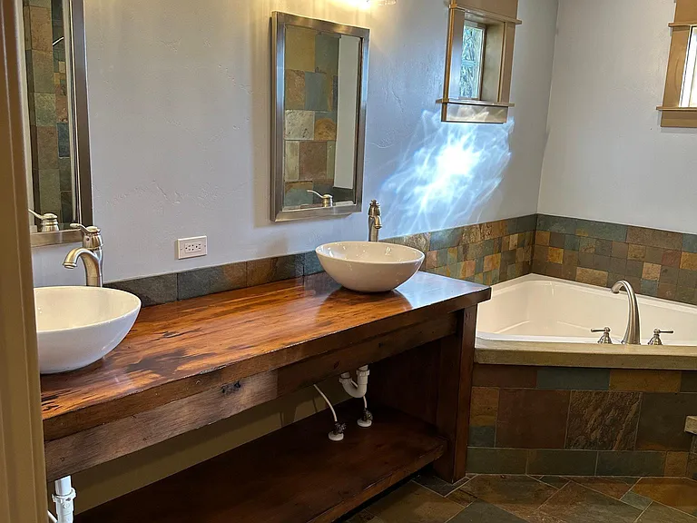 Master bedroom en suite with dual sinks, jetted bath tub and new light fixtures
