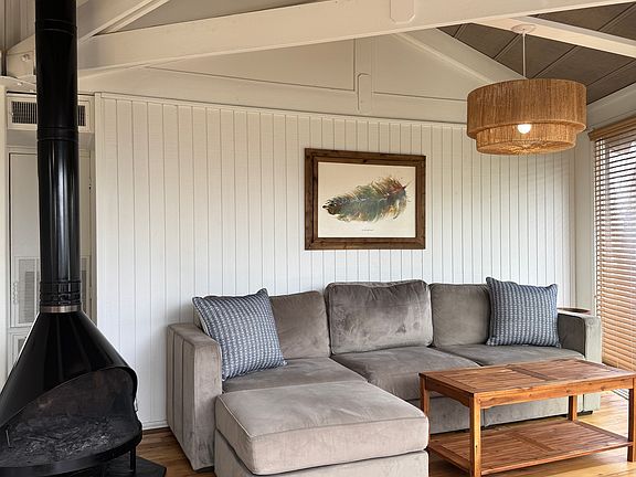 Cozy living room with wood burning fire place.