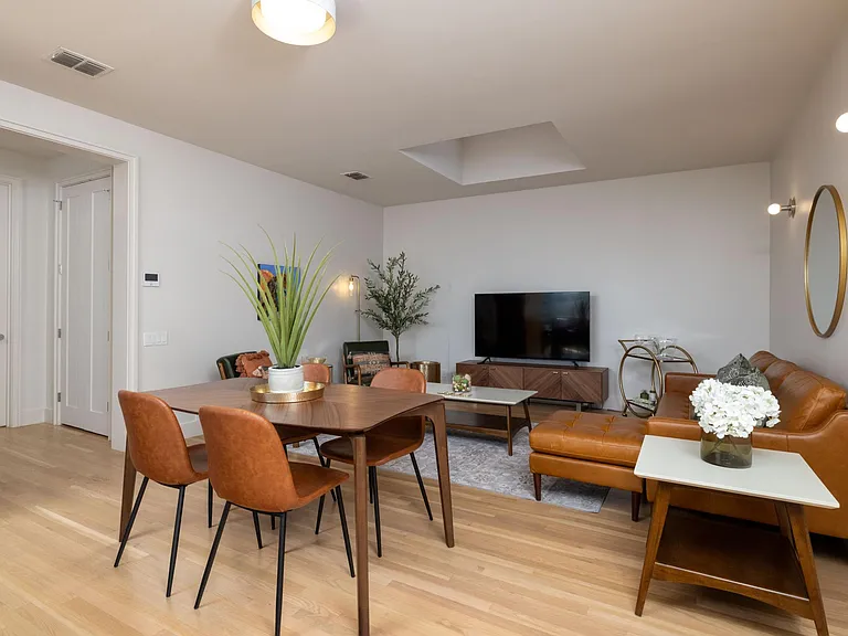 Dining area situated between the living room and kitchen, featuring a table with comfortable seating for 4_perfect for meals and gatherings.