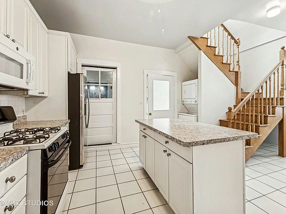 Modern kitchen with upgraded appliances and washer/dryer in-unit.