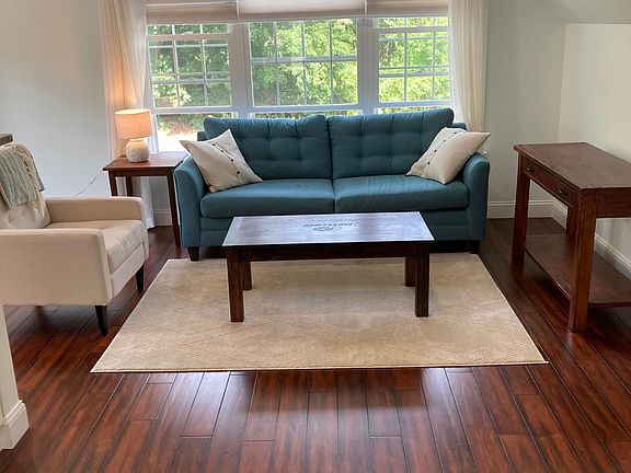 Open-concept living room and kitchen with lots of natural light and pretty view
