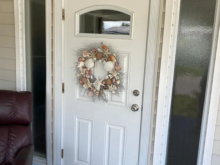 Front door into LR off the front "stoop" that is getting a new roof along with the sun porch behind it. Thus the lowered rent price.